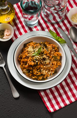 Italian risotto with tomato sauce on the table.