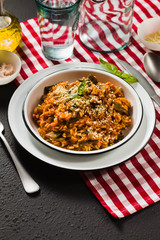 Italian risotto with tomato sauce on the table.