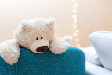 Teddy bear on a chair in a room