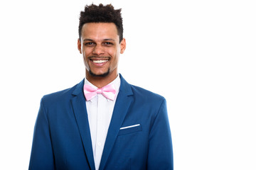 Studio shot of young happy African businessman smiling