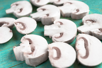 Sliced raw white champignons preparing for cooking