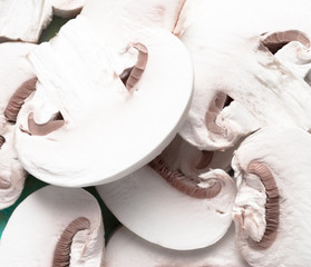 Fototapeta na wymiar Sliced raw white champignons preparing for cooking
