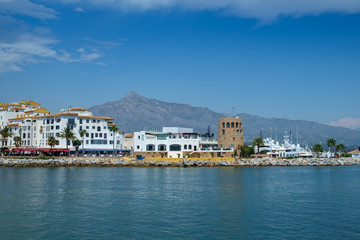 Fototapeta na wymiar Puerto Banus, Marbella, Costa del Sol, Spain. Whitewashed buildings and shops serve as a backdrop to nthis harbour of marine vessels of all sizes from small dinghies to luxury yachts.