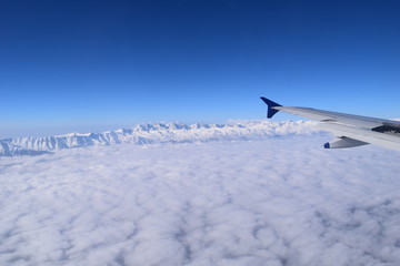 Naklejka na ściany i meble snow and clouds from the plane