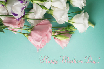 Mothers day card. White eustoma flowers on a light turquoise background