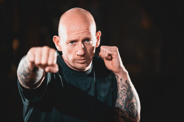 Male MMA Martial Artist fighter punching towards the camera