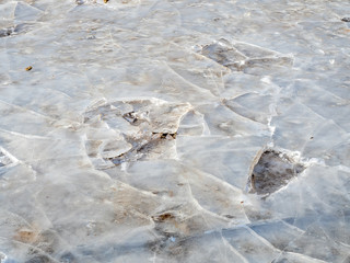 Cracked ice plate on ground in winter season