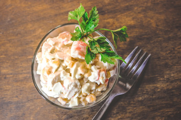 salad of sweet corn, crab sticks and mayonnaise. on wooden background.