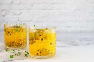 glass of passion fruit juice on marble table