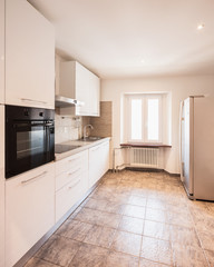 White kitchen with black oven and tiles