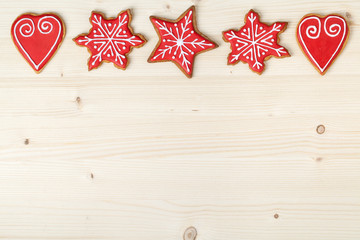christmas homemade gingerbread cookies on wooden background with empty copy space for text. snowflake and star shapes. holiday, celebration and cooking concept. new year and christmas frame