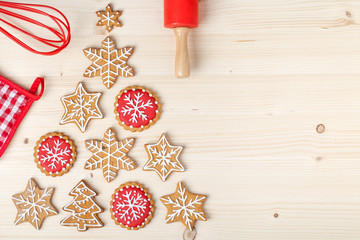 baking tools and christmas tree made from homemade gingerbread cookies on wooden background with empty copy space for text. holiday, celebration and cooking concept. new year and christmas postcard