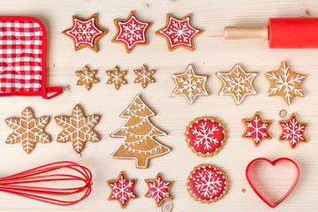 baking tools and christmas homemade gingerbread cookies on wooden background. snowflake, star, christmas tree shapes. holiday, celebration and cooking concept. new year and christmas postcard