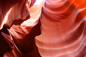 Amazing red sandstone nature background. Swirls of old sandstone wall abstract pattern in red colors in the Antelope Canyon, Page, Arizona, USA. 