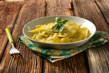 ravioli stuffed with spinach and ricotta with cheese and basil - italian food
