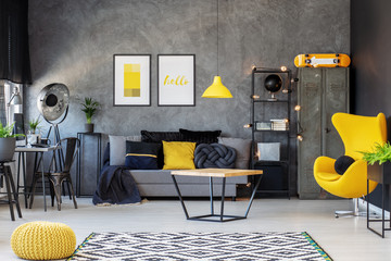 Grey and yellow scandinavian living room with stylish egg chair, modern coffee table and...