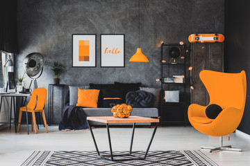 Grey and orange scandinavian living room interior with stylish egg chair, modern coffee table...