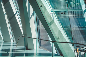 Obraz premium Modern architecture. Lines in construction. White interior. Design solution. Big windows. Glass. Beams. Grid of ropes. Stairs. The museum.