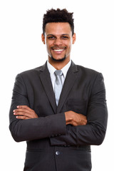 Studio shot of young happy African businessman smiling with arms
