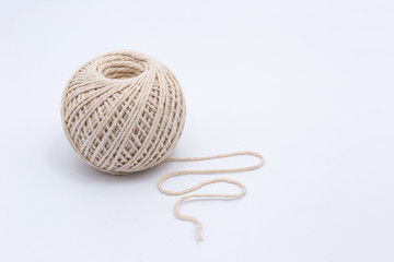 A ball of string with soft shadows on a white background. Copy space.