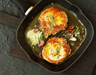 Fried pork steak in a frying pan.