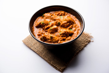 Murgh Makhani / Butter chicken tikka masala served with roti / Paratha and plain rice along with onion salad. selective focus
