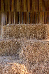 golden colored hay bale sitting inside a rustic wooden ranch building