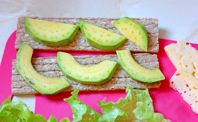 two sandwiches with avocado