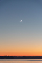 Crescent moon over horizon puget sound 