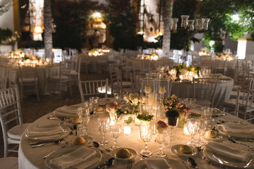 Decorated table for a wedding at night with candles