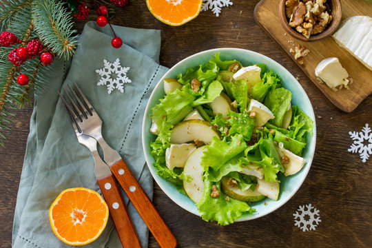 Pear Salad, Walnut, Camembert Cheese And Vinaigrette Dressing On A Festive Christmas Table.Traditional French Cuisine. Top View Flat Lay Background. Copy Space.