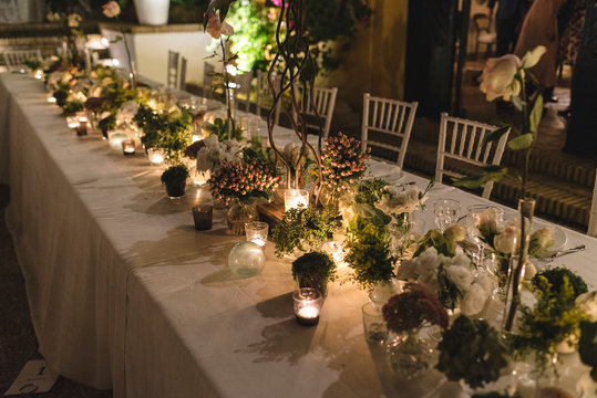 Floral arrangement in a decorated table for a wedding at night with candles