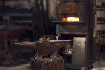 Mallet on an anvil in front of a furnace