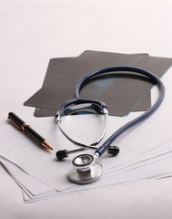 stethoscope,x-ray and pen on the table. photo with copy space