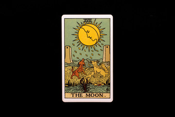 An individual major arcana tarot card isolated on black background. The Moon. - obrazy, fototapety, plakaty
