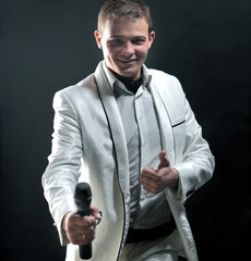 Naklejka premium handsome male singer. isolated on black background