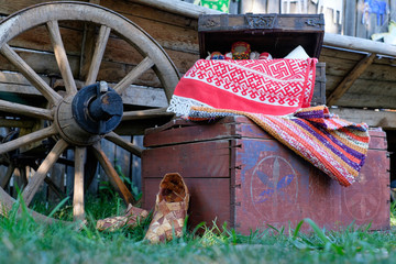 cart wheel, bast shoes, chest