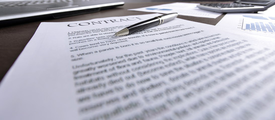 blurred image of a sheet with a contract on a Desk