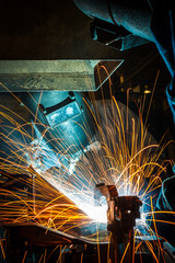 worker with protective mask welding metal