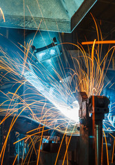 worker with protective mask welding metal