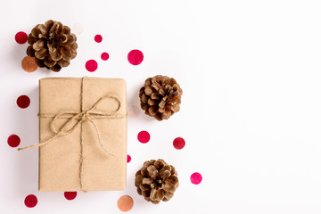 Festive composition with beautiful presents wrapped in craft paper and tied with a ribbon, multiple colorfull round shaped confetti on background. Close up, copy space, top view, flat lay.