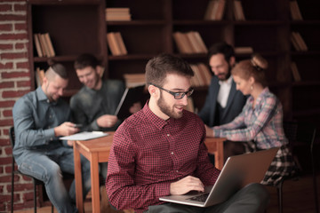 designer working on a laptop in a modern Studio