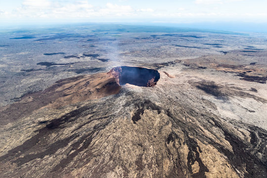 aerial view of Puu Ooo Volcanic cone on the Big Island of Hawaii. Volcanic gas can be seen escaping from the crater. 
