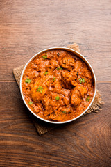 Murgh Makhani / Butter chicken tikka masala served with roti / Paratha and plain rice along with onion salad. selective focus