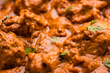 Murgh Makhani / Butter chicken tikka masala served with roti / Paratha and plain rice along with onion salad. selective focus