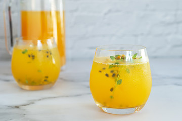 glass of passion fruit juice on marble table