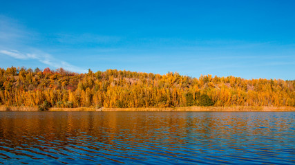 Fantastic lake in beautiful autumn orange forest