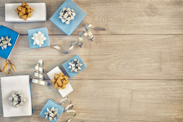 Christmas composition with copy space. Decorative ribbons, white and blue gift boxes with beautiful bows.