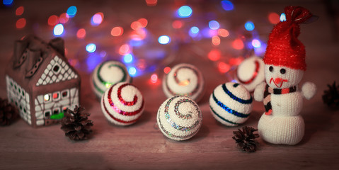 Christmas balls and a toy snowman on Christmas table