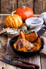 Roasted chicken thighs with sliced butternut squash pumpkin and fresh thyme